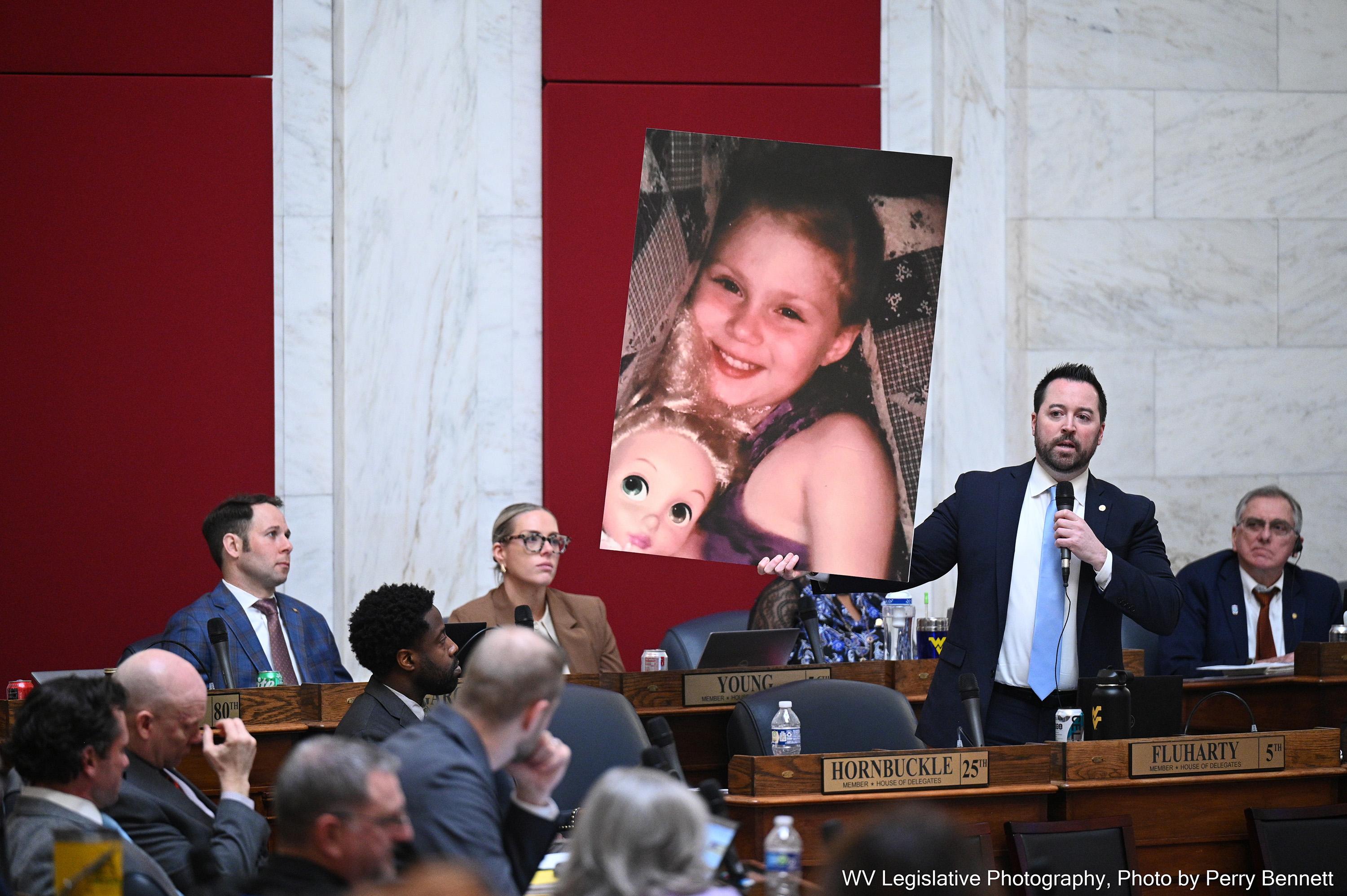 Shawn Fluharty, a Democrat, holds up a poster of Raylee Browning, a child who died from abuse and neglect after her parents removed her from public school to homeschool her. (WEST VIRGINIA LRIC/TNS/TNS)
