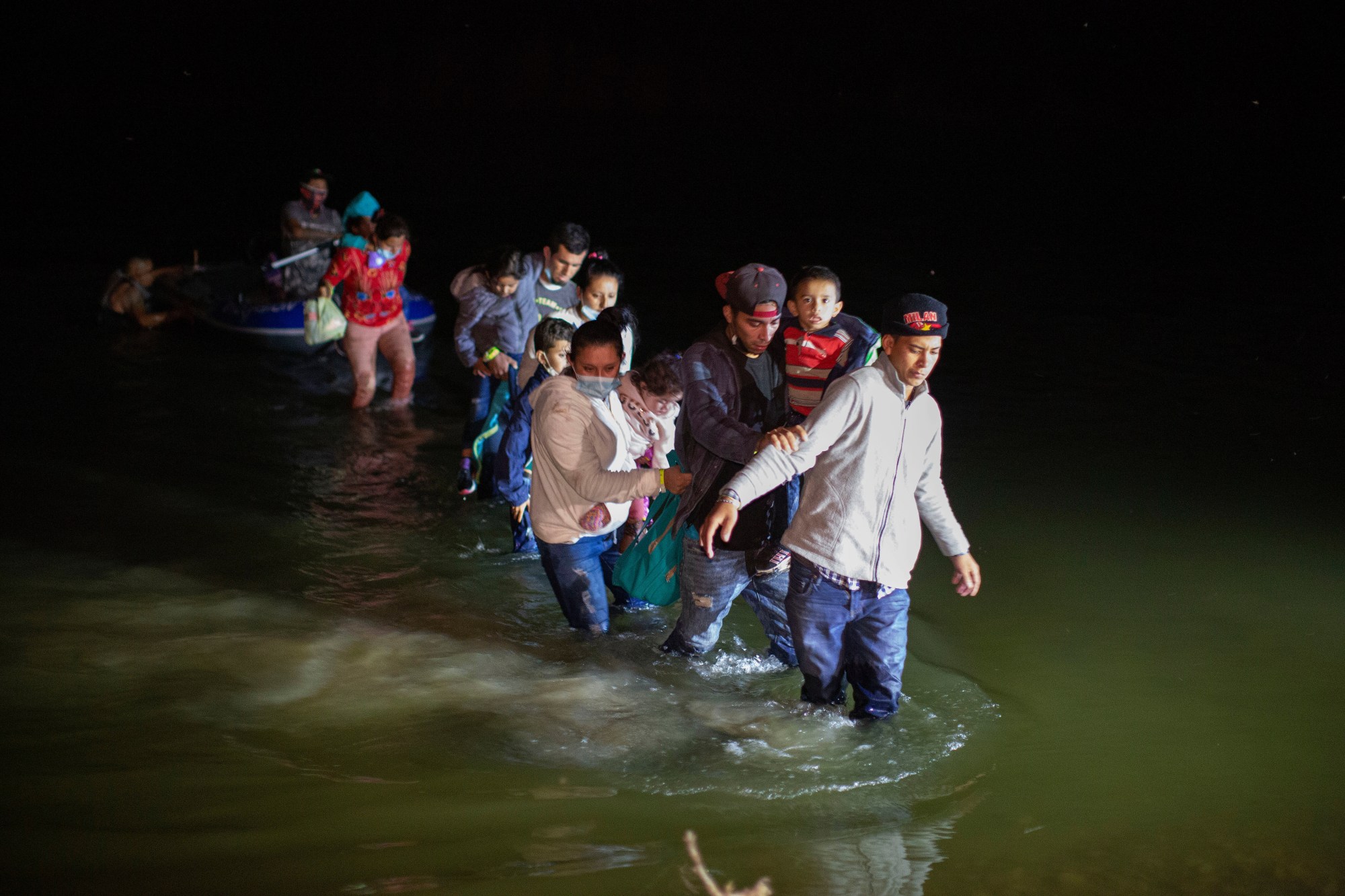 FILE – Migrant families wade through shallow waters toward Roma, Texas, March 24, 2021. (AP Photo/Dario Lopez-Mills, File)
